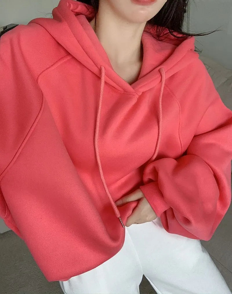 Women's watermelon red Mulberry Silk hooded sweater on a hanger, showing loose fit and front design.