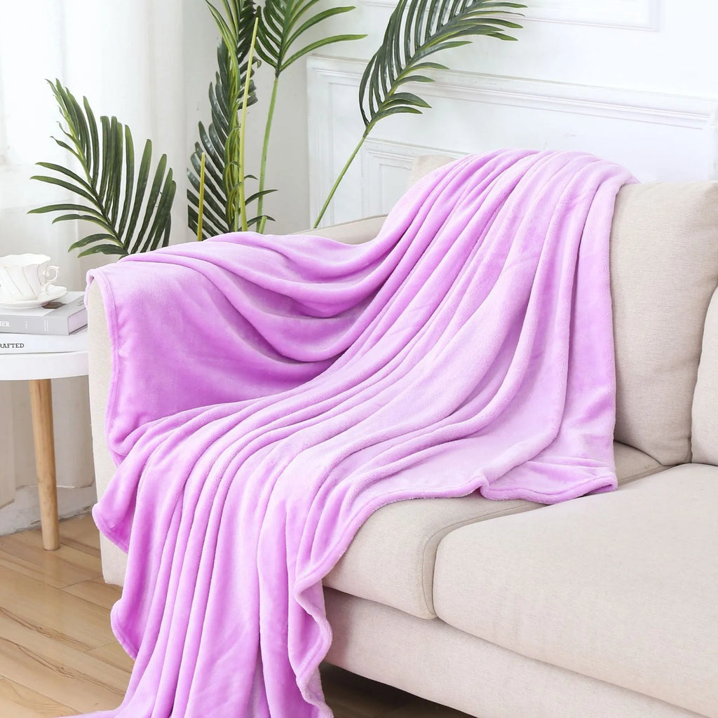 Solid colour polyester flannel blanket in big red, lying flat on a surface