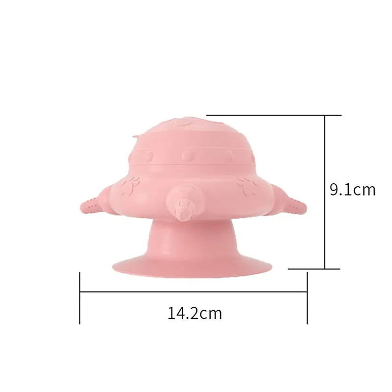 Pink silicone pet nursing milk feeder bowl with four pacifiers on a flat base.