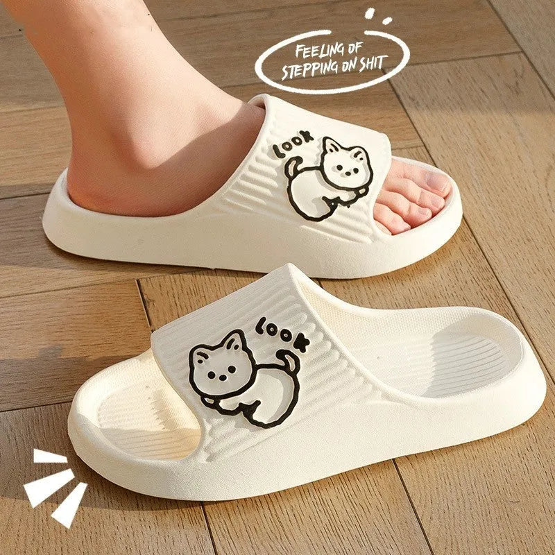 Women's green cat slippers with thick EVA platform sole on a wooden floor