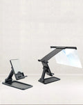 Black folding mobile phone screen amplifier with detachable holder showing 3-4x magnification