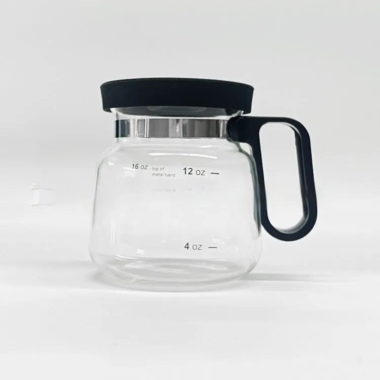 Transparent borosilicate glass coffee jug with black silicone cover on a kitchen counter