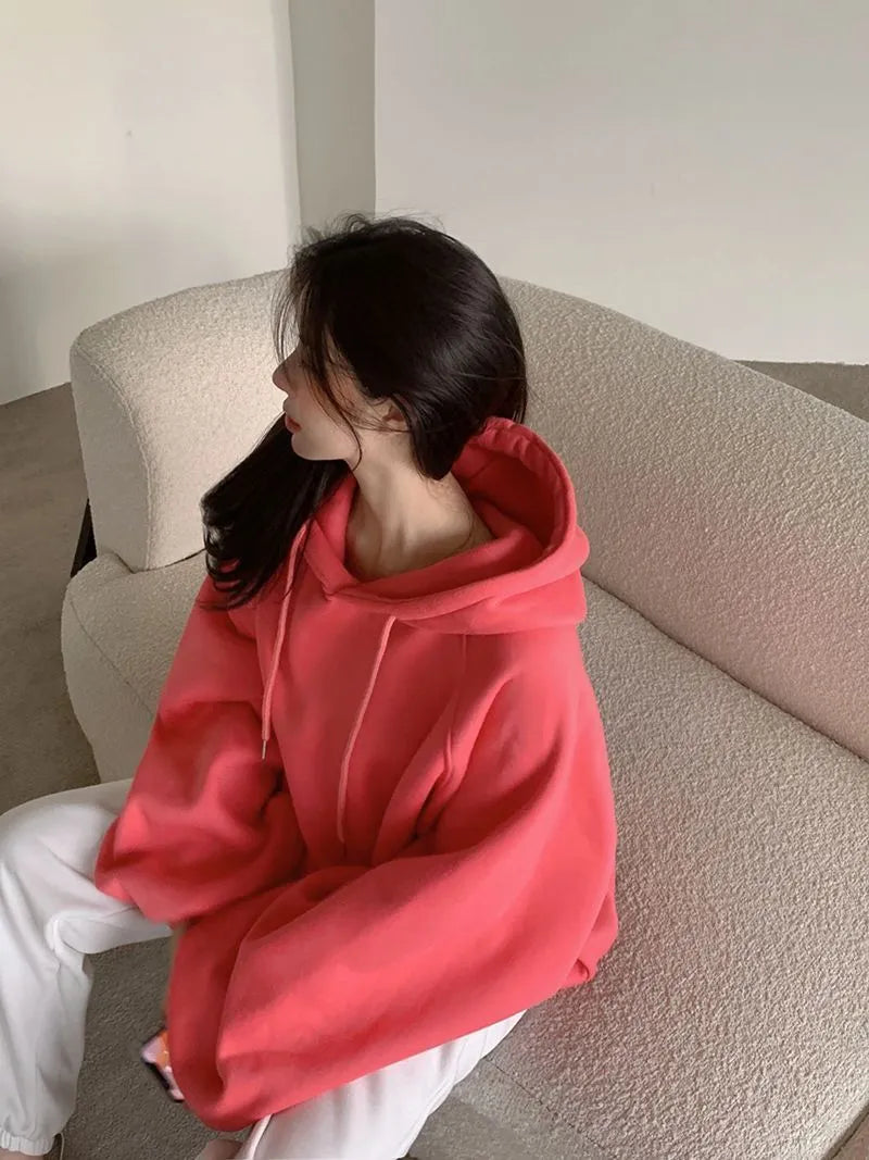 Women's watermelon red Mulberry Silk hooded sweater on a hanger, showing loose fit and front design.