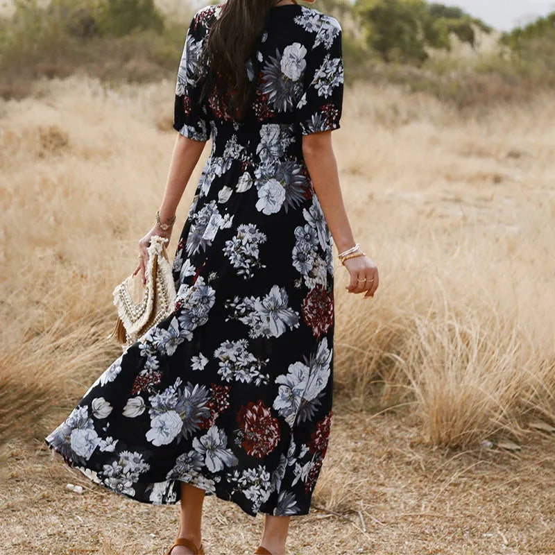 Yellow floral print women's dress with V-neck, short sleeves, elastic high waist, and a full mid-length skirt.
