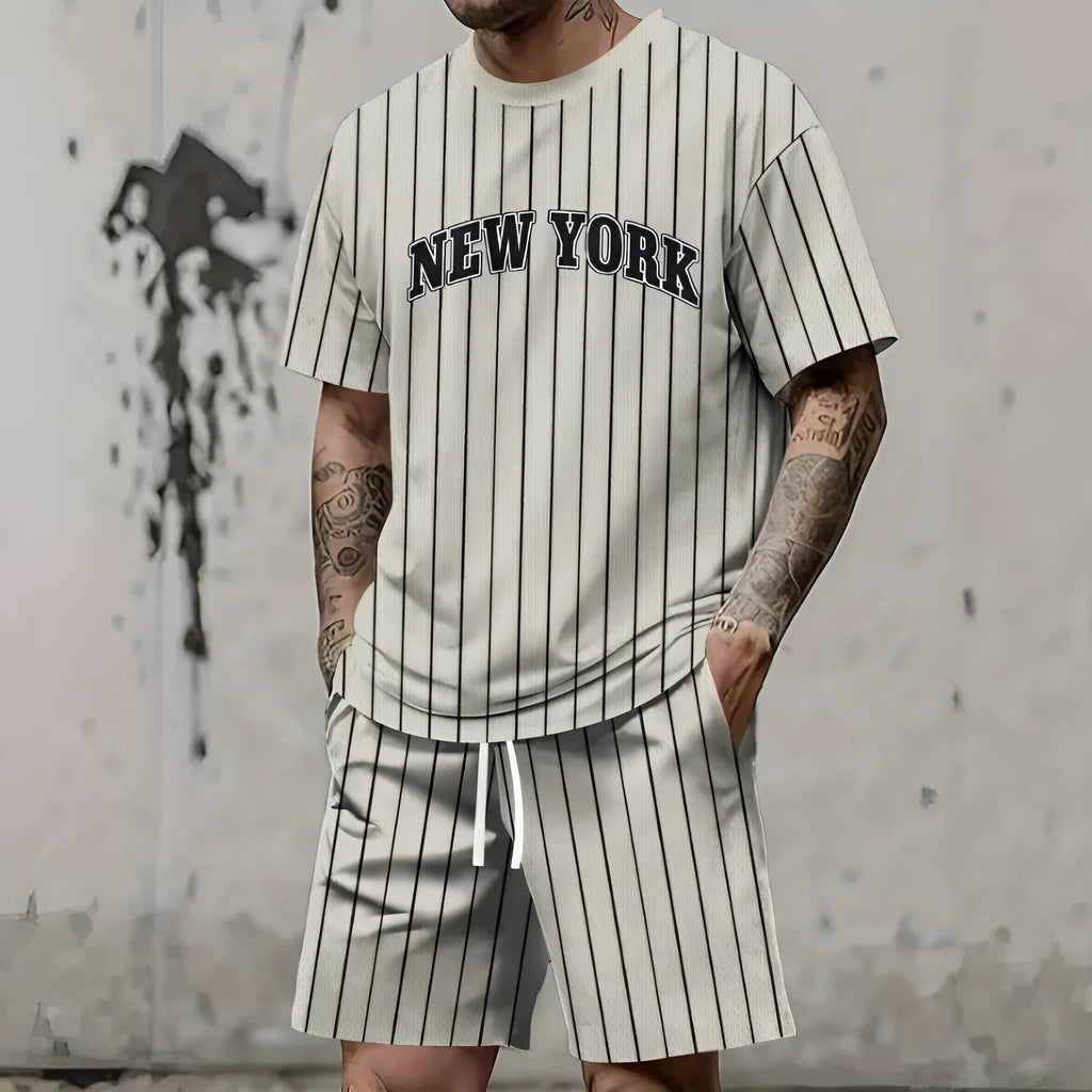 Men's grey sports suit with 3D printed white lettering on the short sleeve top and matching shorts.