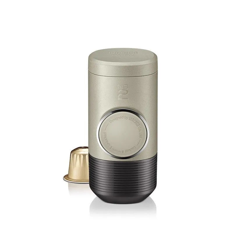 Olive gray manual espresso portable capsule coffee machine with storage bag and accessories on outdoor table