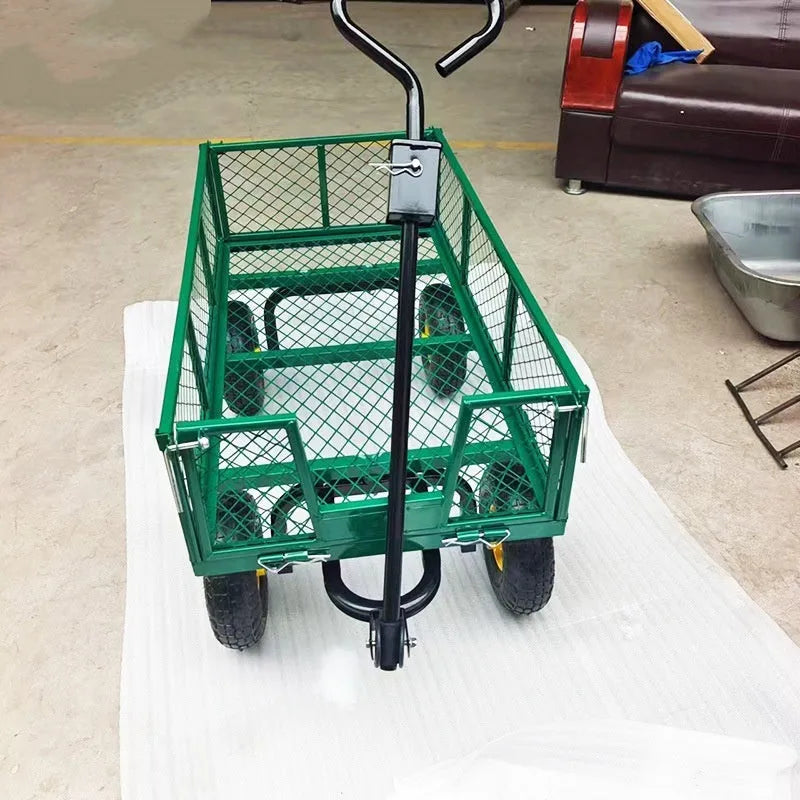 Green four-wheel hand push net cart with iron frame and rubber wheels on outdoor ground