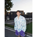 Long sleeve floral shirt with embossed three-dimensional pattern in polyester blend fabric available in pink or blue