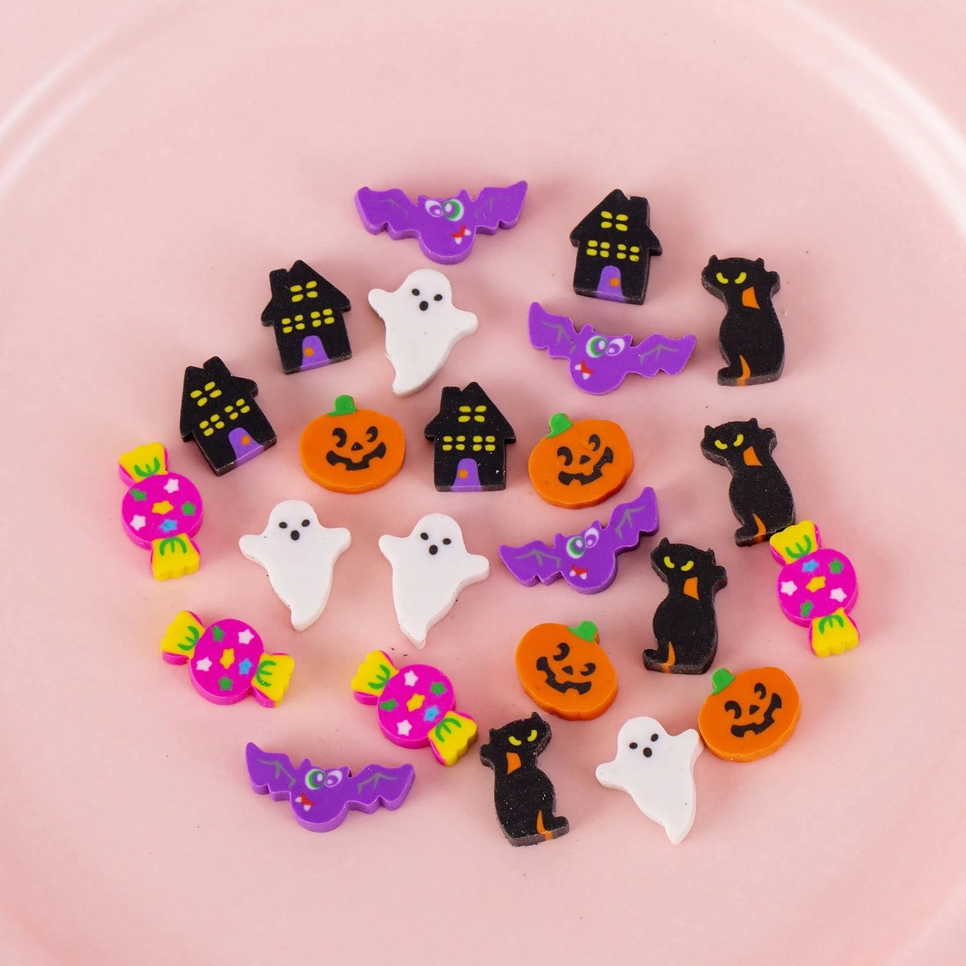 Assortment of fifty small cartoon-shaped rubber erasers in fruit and animal designs.