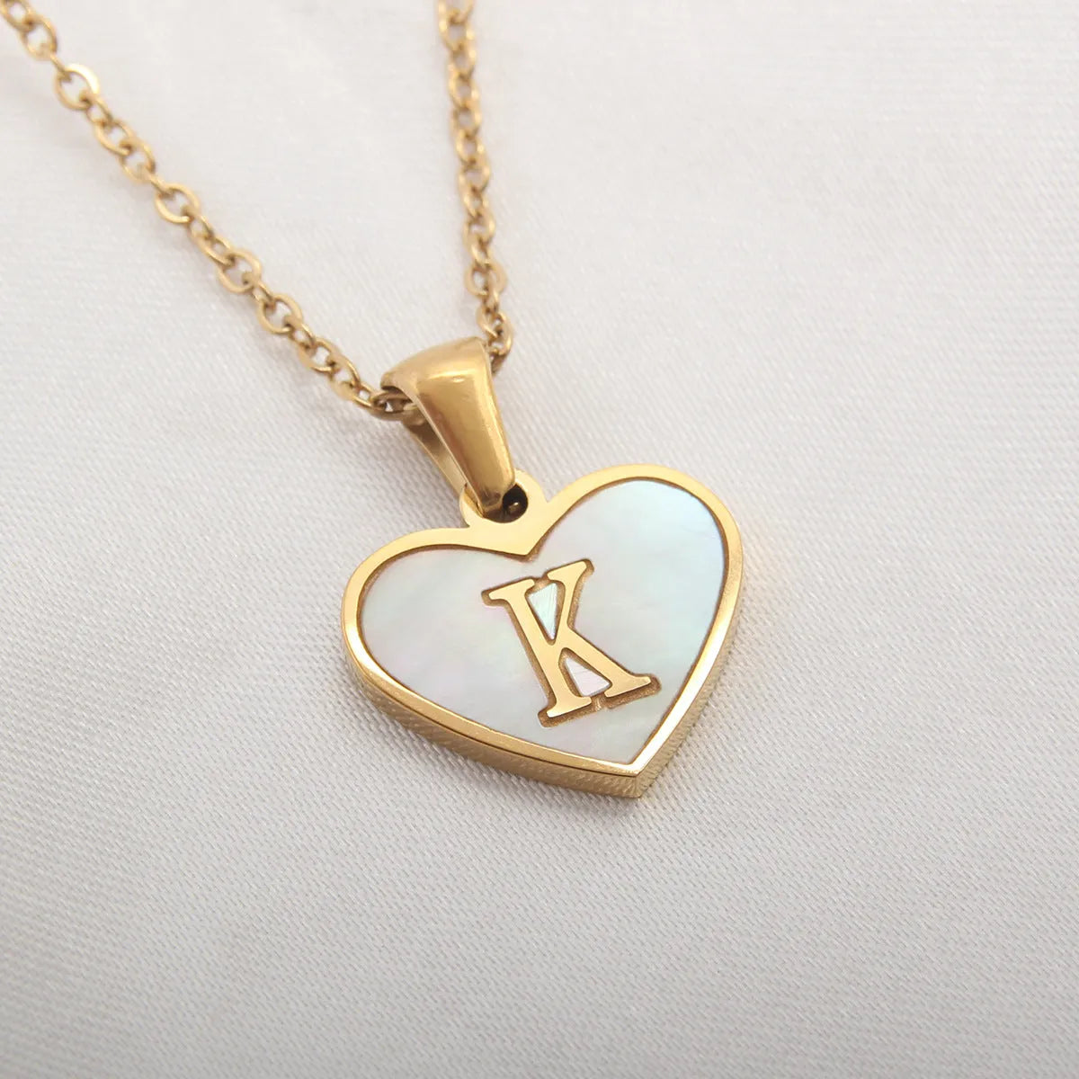 Gold heart necklace with white shell pendant and initial charm on 45cm adjustable chain