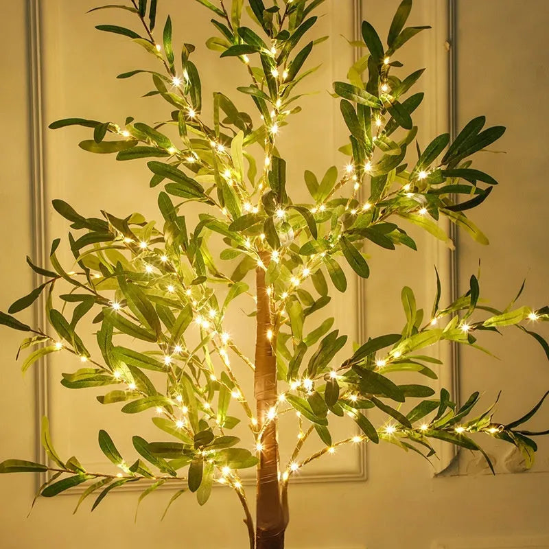 1.8 metre tall artificial olive tree lamp with warm LED lights illuminating courtyard decoration