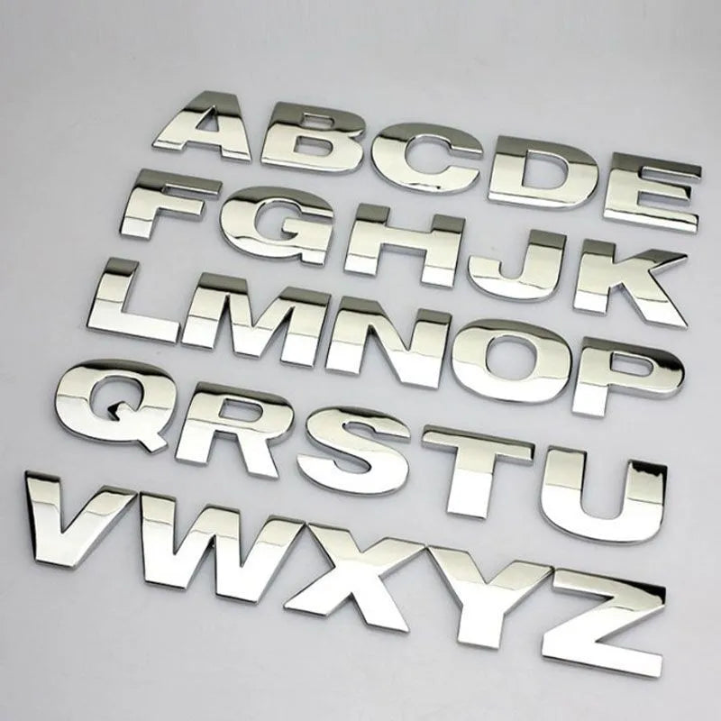 Close-up of a single 3D metal car letter sticker in zinc alloy on a vehicle bumper.