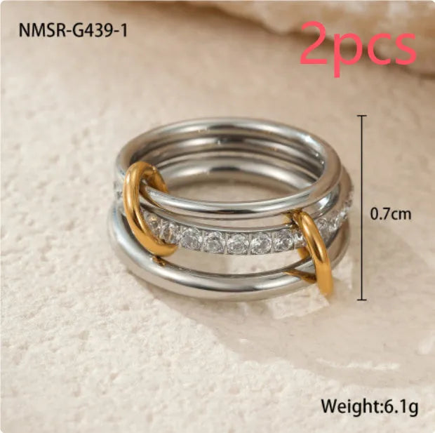 Stacked stainless steel rings with 18K gold plating in exaggerated design on woman's hand