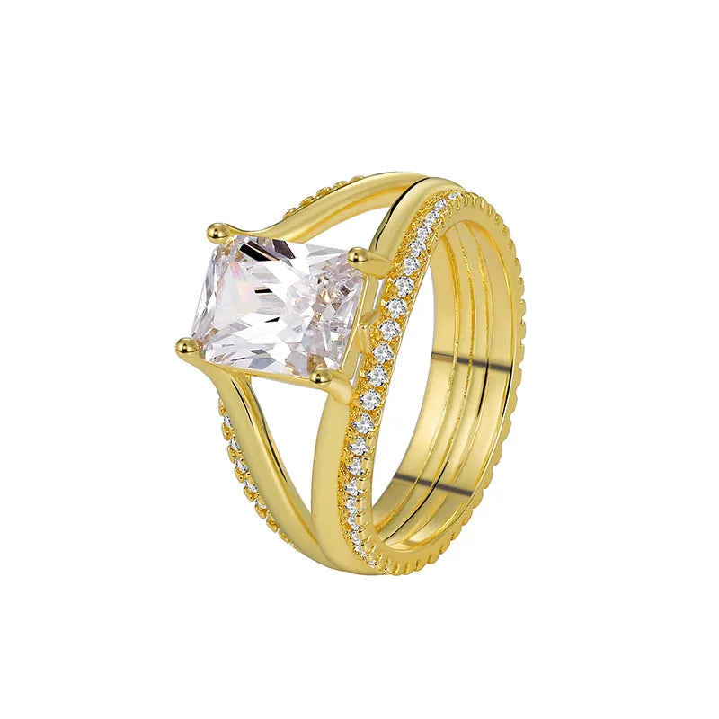 Geometric gold-coloured women's ring with a square zircon stone on a copper band.