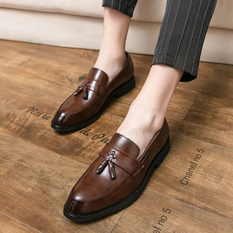 Men's black slip-on loafers with tassel detail and rubber sole for business casual wear