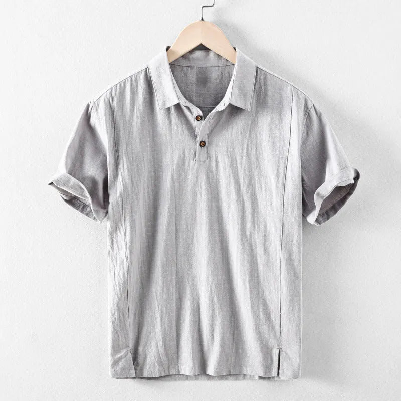 A man's loose-fit linen casual shirt in a solid colour, shown in light grey, featuring long sleeves and a button front.