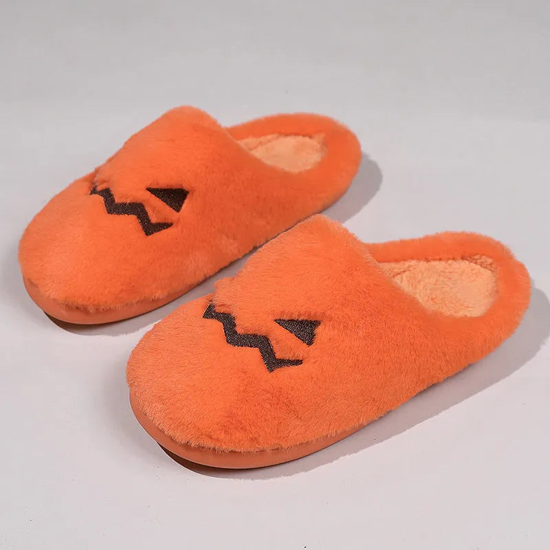 Orange Halloween pumpkin slippers with coral velvet upper and plush lining.