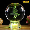 White crystal ball luminous ornament with Chinese zodiac animal design on an electronic charging base.
