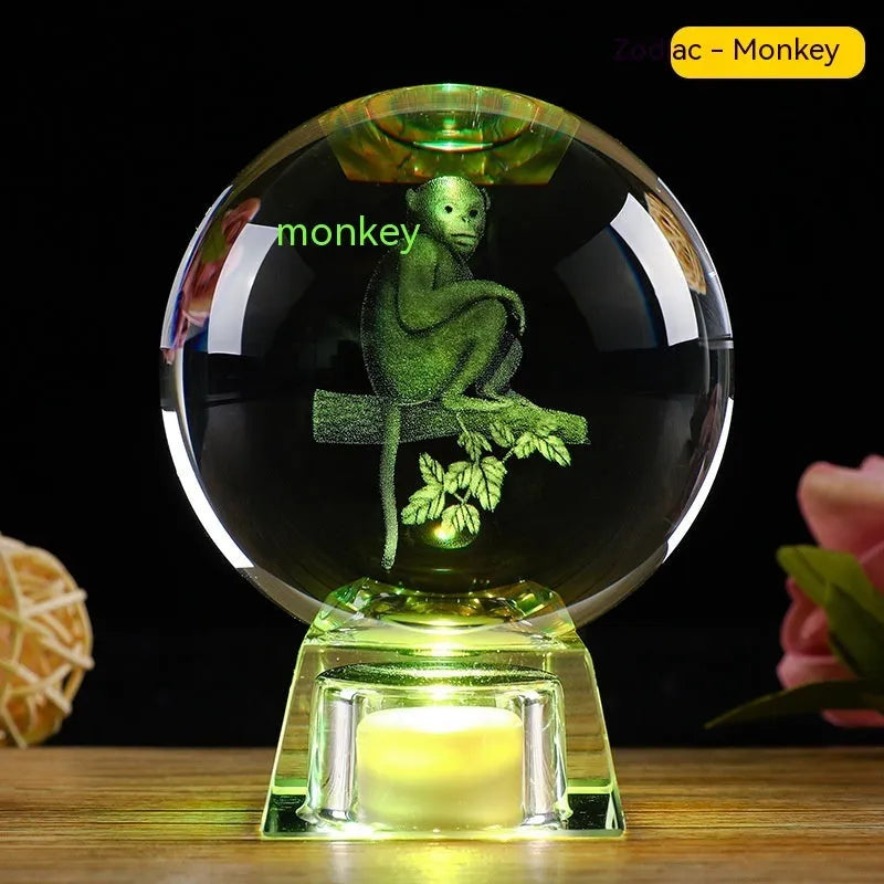 White crystal ball luminous ornament with Chinese zodiac animal design on an electronic charging base.