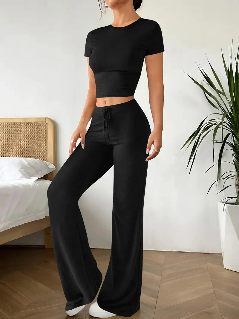 Black polyester women's high waist trousers and short sleeve t-shirt suit on hanger
