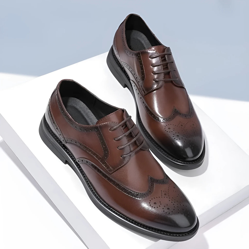 Men's black and brown brogue leather shoes with decorative perforations, shown on a white background.