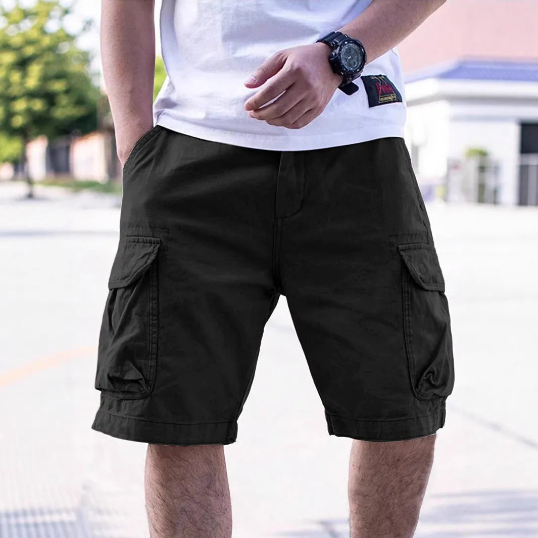 Man wearing loose-fitting army green cotton-blend retro workwear shorts for summer.