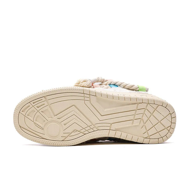 Creamy white Old Damage retro skate shoes with lace-up front, low-top platform heel, and rubber sole.