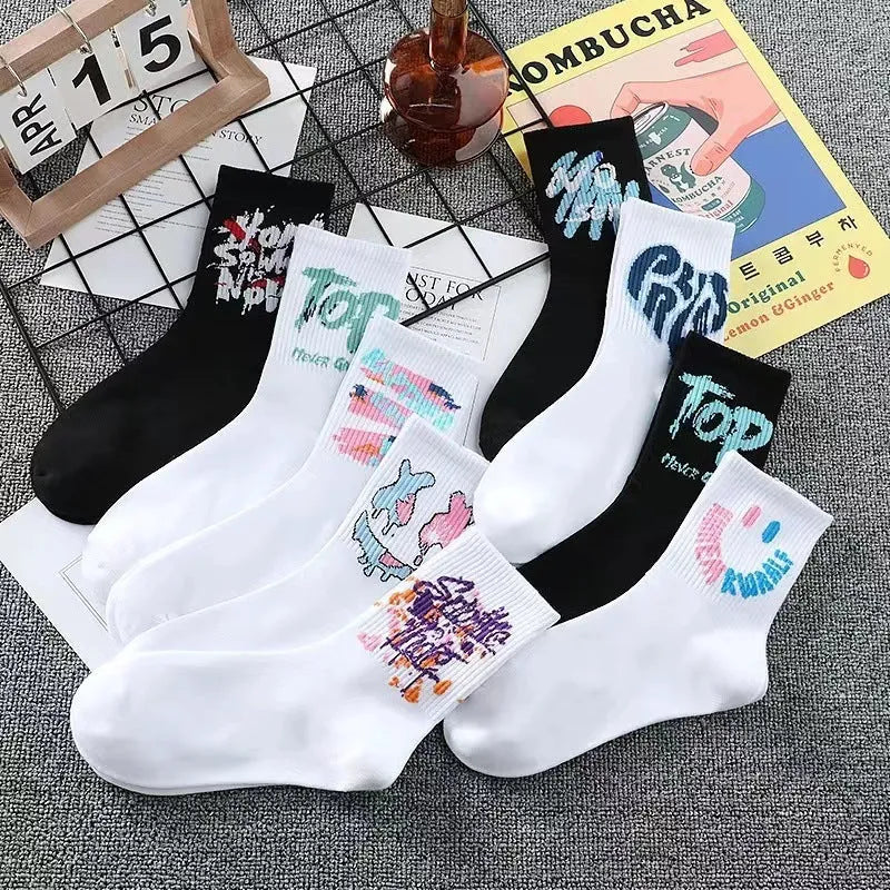 10 pairs of white cotton tube socks with graffiti pattern, middle calf length, on a plain background