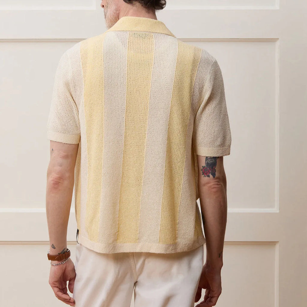 Yellow short-sleeved polo shirt with asymmetric design and hollow-out pattern details