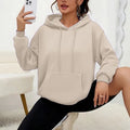 Women's loose grey drawstring hooded sweatshirt with side pockets, on a hanger.