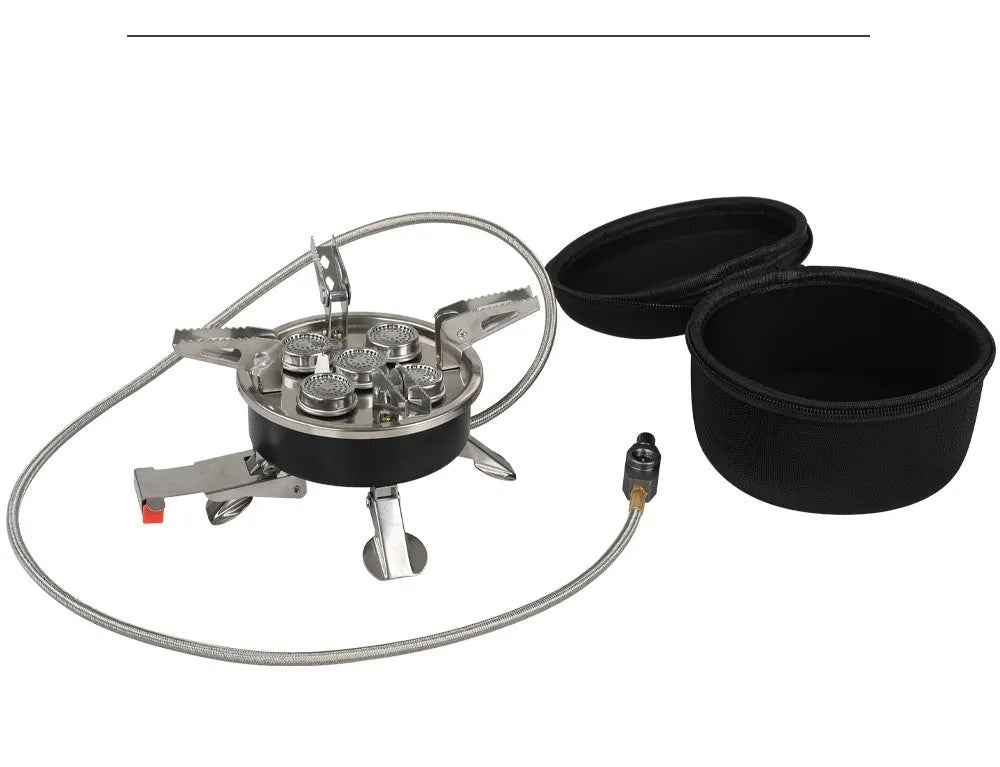 Silver foldable split camping stove with extended gas hose on a grey background
