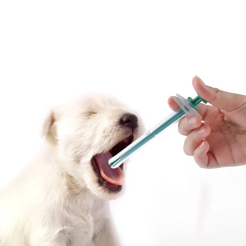 Two silicone pet pill shooters, one larger and one smaller, with soft tips and push rods.