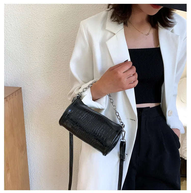 One shoulder cylinder messenger bag in beige PU leather with embossed crocodile pattern and zipper closure
