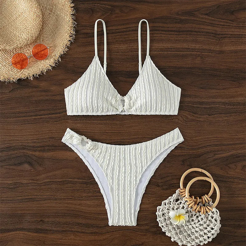 White women's V-neck beach swimsuit with split style and sleeveless design.