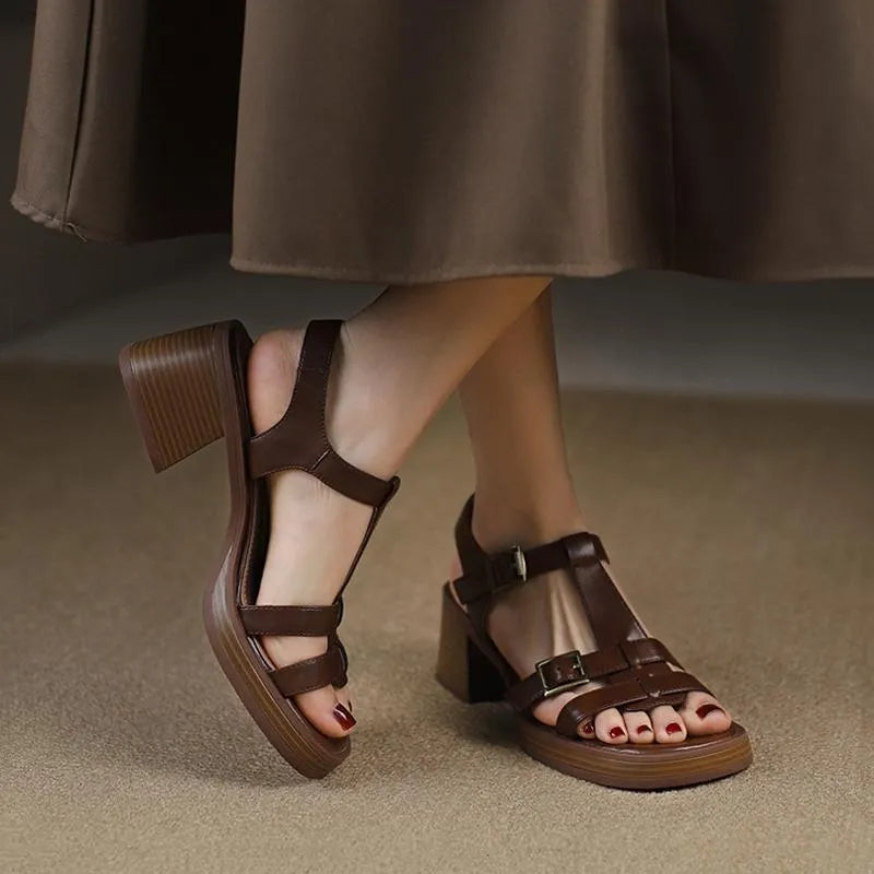 Women's black retro sandals with a T-shaped buckle, open square toe, platform, and chunky heel.