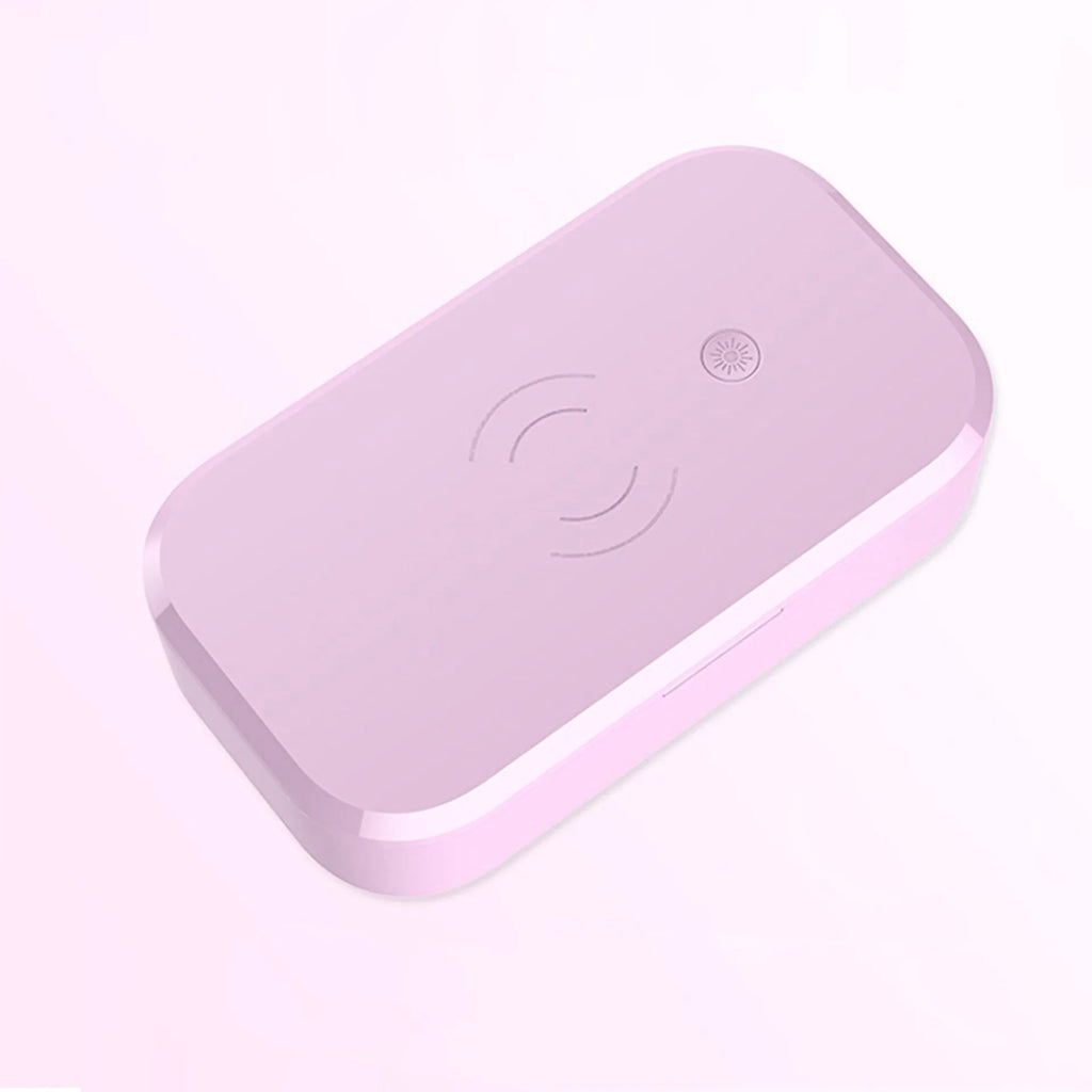 Compact white ultraviolet disinfection box with wireless phone charging pad on top.