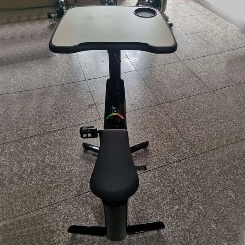 Black upright exercise bike with magnetic resistance and built-in table for home fitness
