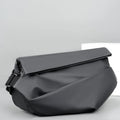 Grey PU leather crossbody sling backpack for men showing horizontal square shape and shoulder strap
