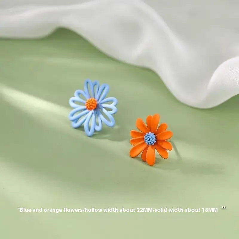 Alloy flower-shaped stud earrings in two-tone blue orange, white green, and yellow white colour combinations.