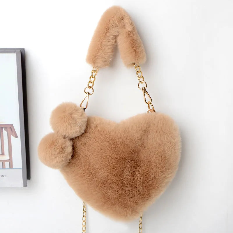 Soft plush heart-shaped women's handbag in a medium size with a removable shoulder strap.