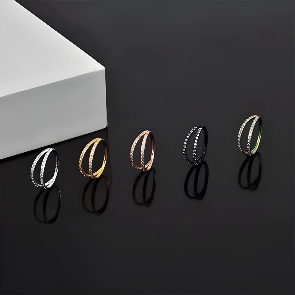 Close-up of a G23 titanium alloy nose or ear ring with a small zircon gemstone, shown in a gold tone finish.