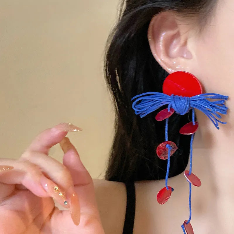 Women's geometric cloth earrings with silver needle and blue resin flower decorative details