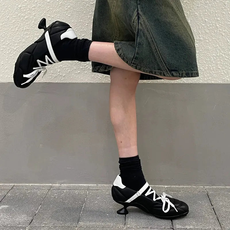 Women's silver lace-up sports-style heeled shoe with a bow detail and round toe.