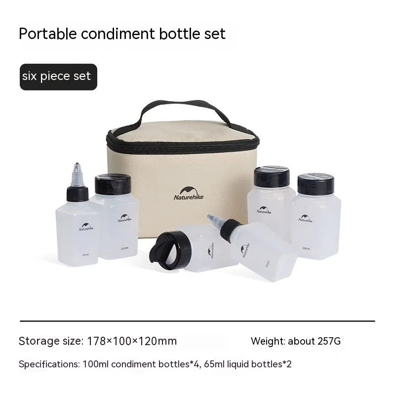 Set of six white portable seasoning bottles with black lids for outdoor picnics and camping.