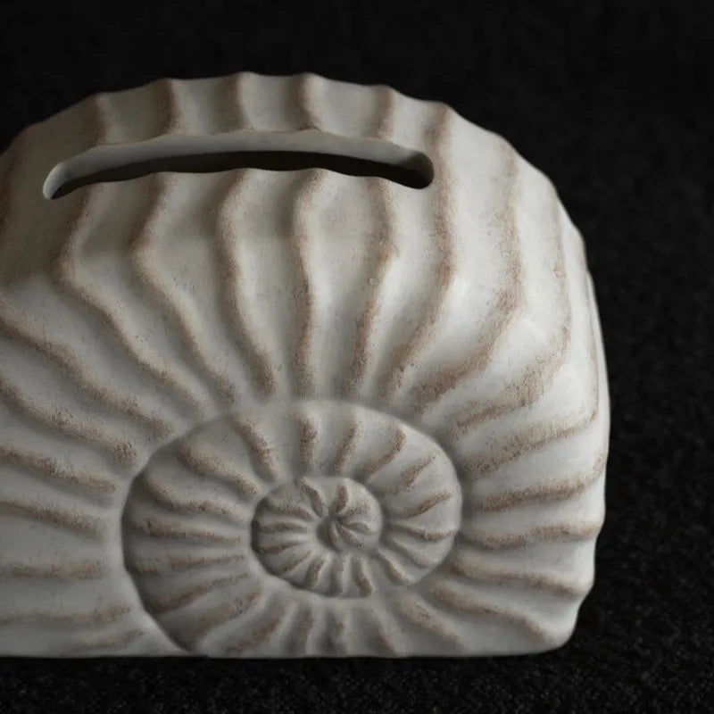 Conch coloured resin tissue box with modern minimalist design for home decor
