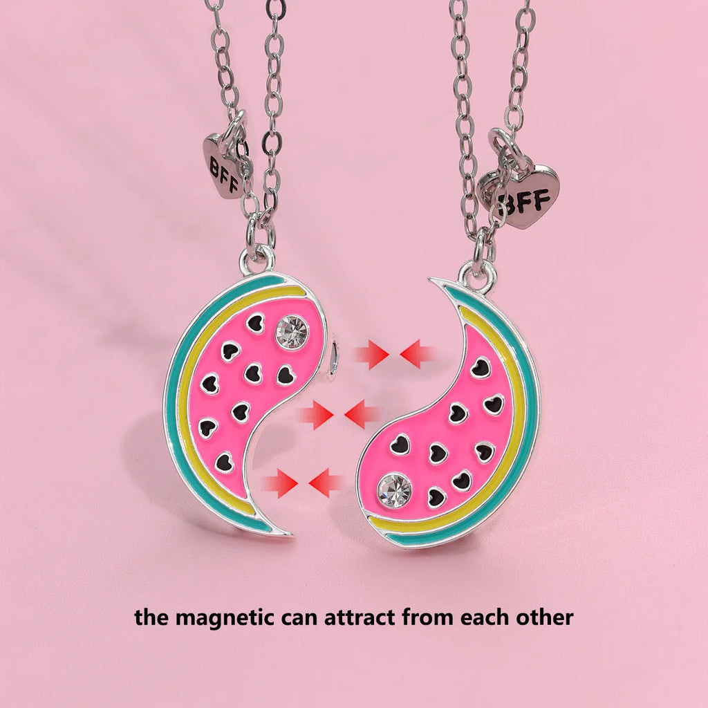 Two matching zinc alloy pendants in donut and watermelon shapes with glossy oil drip finish on cross chains