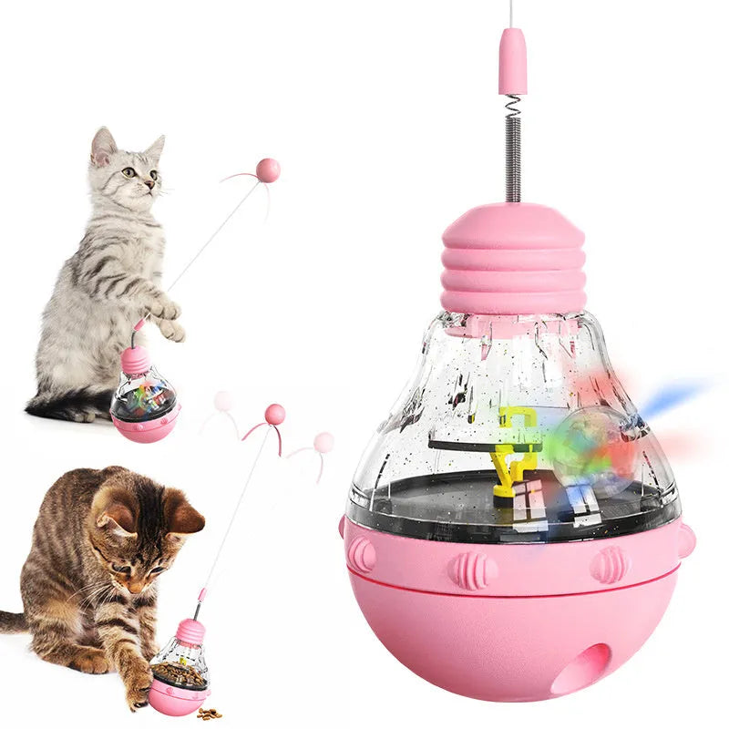 Pink, purple, and yellow tilting cat interactive toy with a bouncing teaser wand and built-in slow feeder.