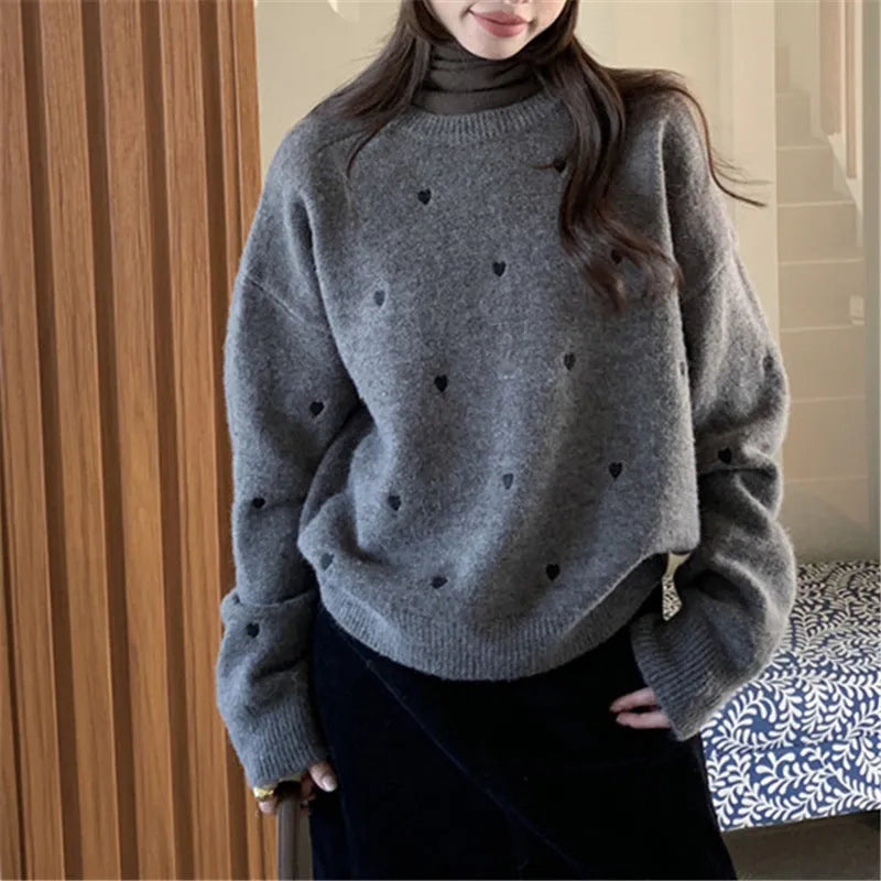 Women's loose fit grey acrylic pullover sweater with embroidery on the front.