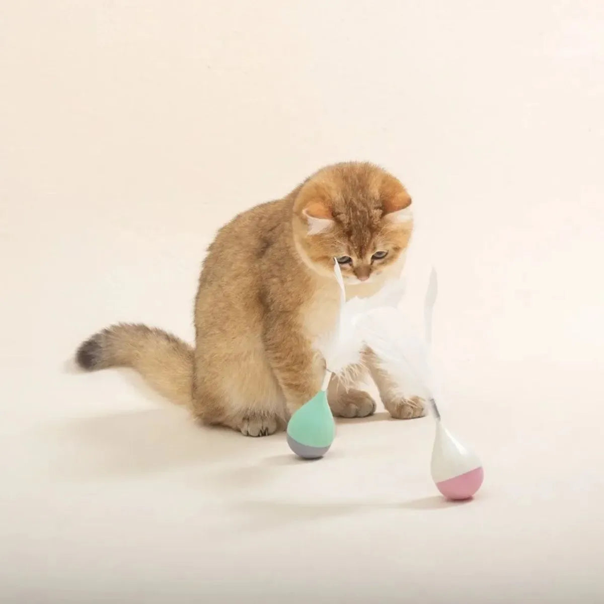 Green feather tumbler cat toy with ABS plastic construction and goose feathers