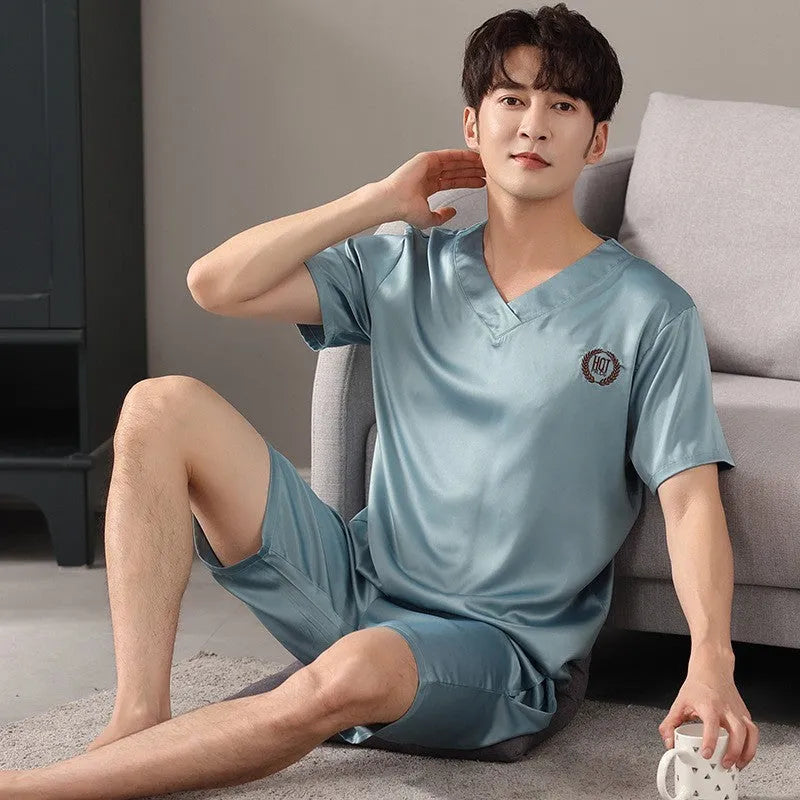 Men's ice silk short-sleeved pajama shirt and loose shorts set on a hanger.
